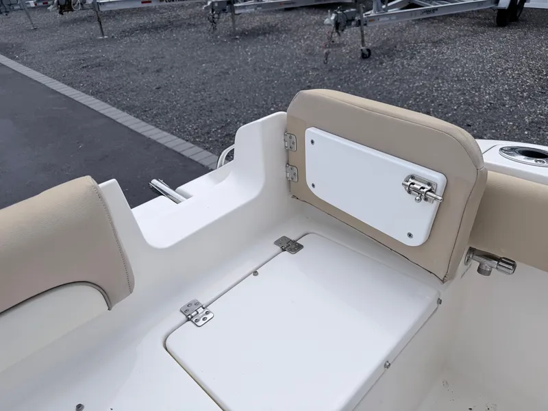 Slide: The Image of The image shows the seating area of a 2014 Key West 219 FS boat with storage. - 23