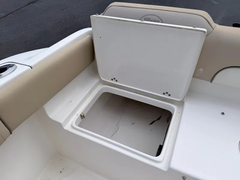 Slide: The Image of An open storage compartment on a 2014 Key West 219 FS boat with beige upholstery. - 25