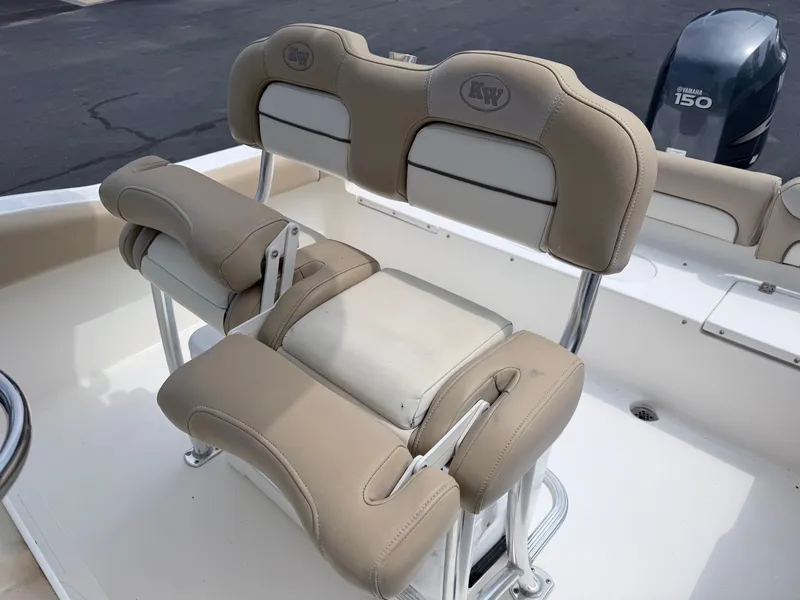 Slide: The Image of The image shows the beige upholstery of the seats on a Key West 219 FS boat. - 19