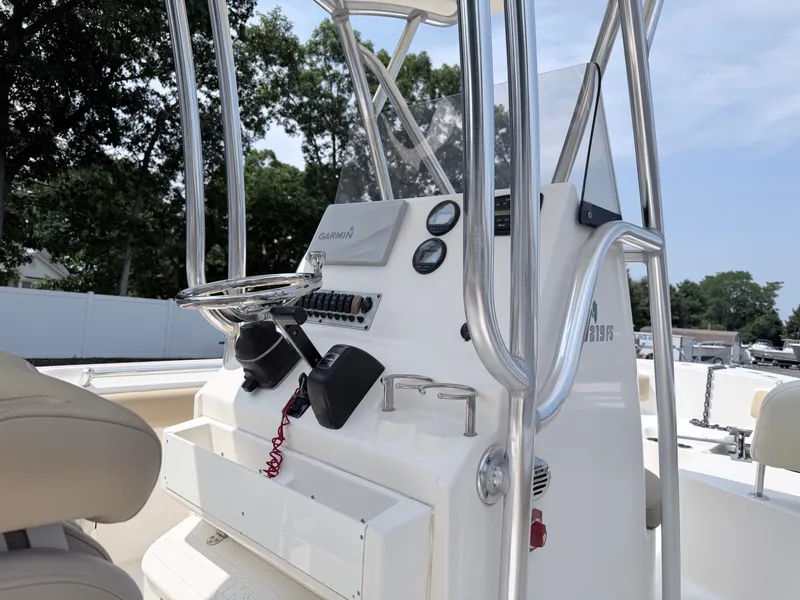 Slide: The Image of The image shows the helm of a 2014 Key West 219 FS boat with navigation equipment. - 13