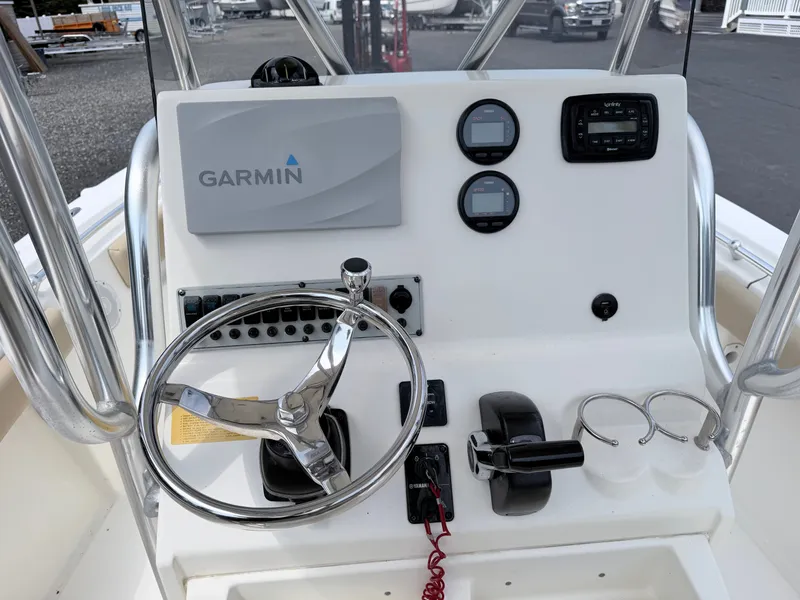 Slide: The Image of The image shows the helm of a 2014 Key West 219 FS boat with Garmin equipment. - 12