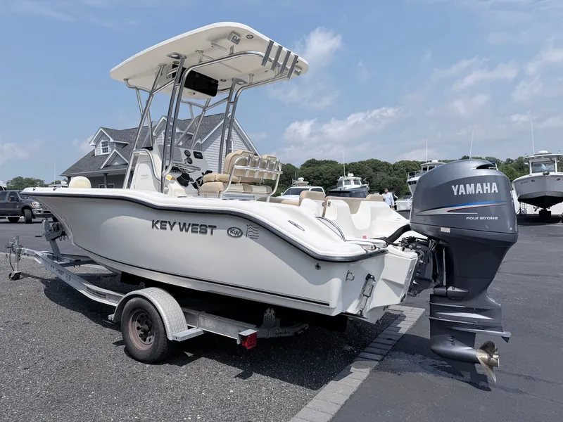 Slide: The Image of A 2014 Key West 219 FS boat on a trailer, featuring a Yamaha outboard motor. - 5
