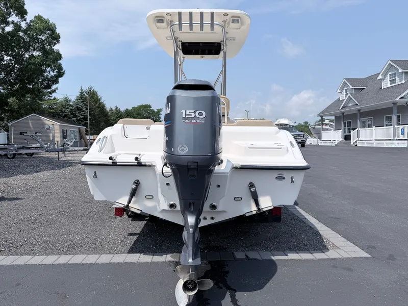 Slide: The Image of A 2014 Key West 219 FS boat with a 150 HP Yamaha outboard motor, parked on asphalt. - 6