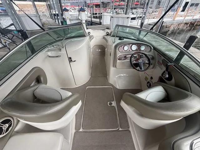 Slide: The Image of The image shows the cockpit of a 2006 Sea Ray 240 Sundeck boat with two seats and a helm. - 23