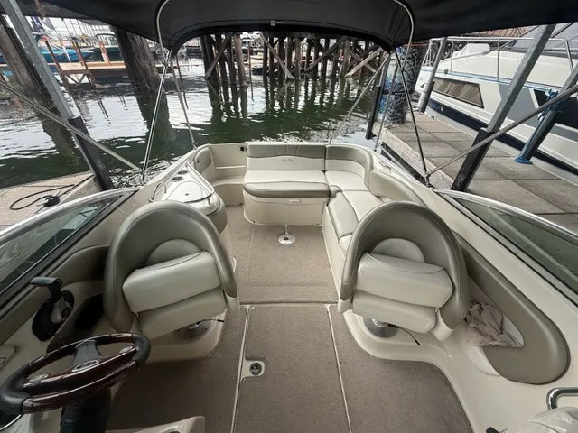 Slide: The Image of The image shows the cockpit of a 2006 Sea Ray 240 Sundeck with beige seating and carpeted floor. - 17