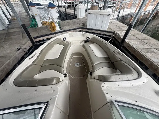 Slide: The Image of The image shows the bow seating area of a 2006 Sea Ray 240 Sundeck with beige upholstery. - 10