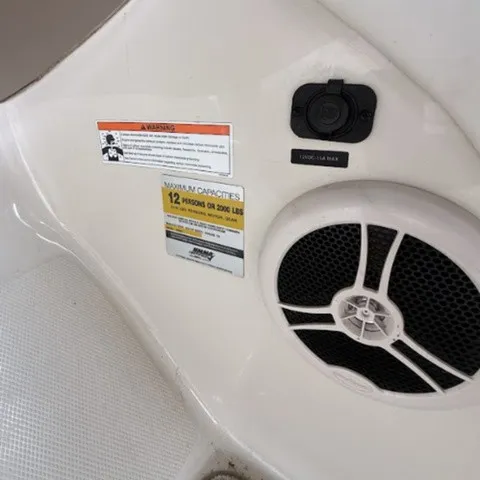 Slide: The Image of Close-up of a speaker and warning label on a Sea Ray 240 Sundeck boat. - 19