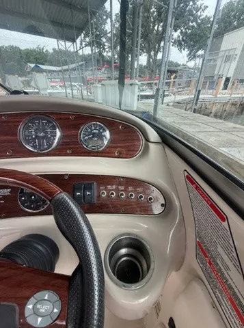 Slide: The Image of The dashboard of a 2006 Sea Ray 240 Sundeck with wood paneling and multiple gauges. - 20