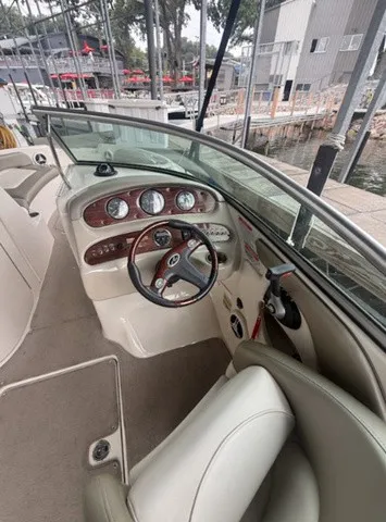 Slide: The Image of The image shows the cockpit of a 2006 Sea Ray 240 Sundeck with a sleek dashboard. - 18