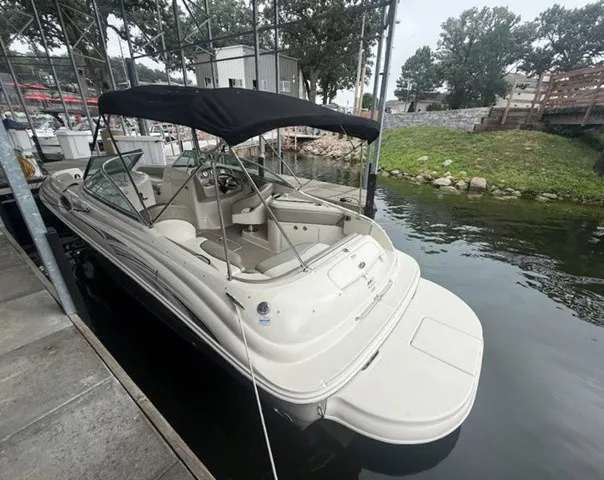 Slide: The Image of A 2006 Sea Ray 240 Sundeck docked. It features a black canopy. - 9