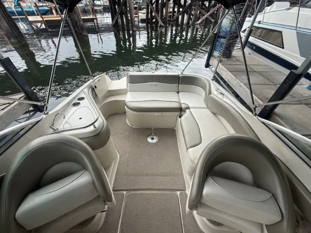 Slide: The Image of The image shows the cockpit of a 2006 Sea Ray 240 Sundeck with beige seating and carpeted floor. - 13