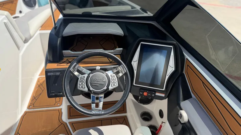 Slide: The Image of The image shows the cockpit of a 2021 Tigé Z3 boat with a modern steering wheel and large display. - 13