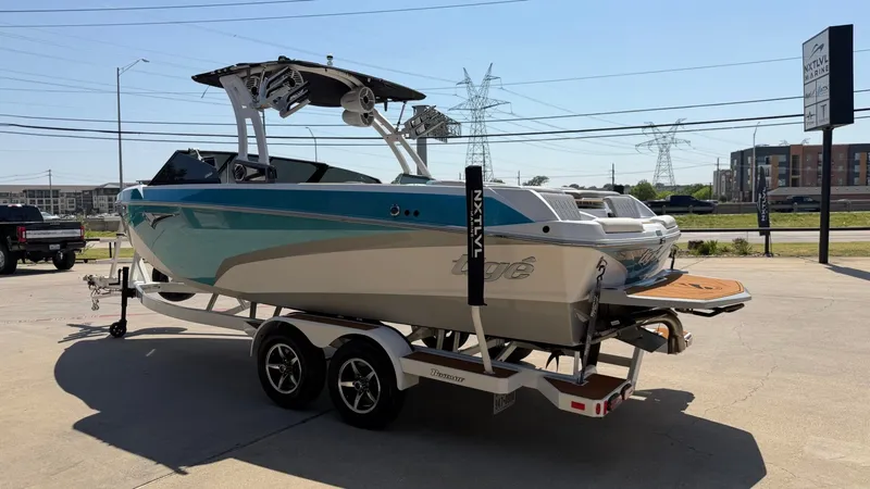 Slide: The Image of A blue and white 2021 Tigé Z3 boat on a trailer in an urban area. - 5