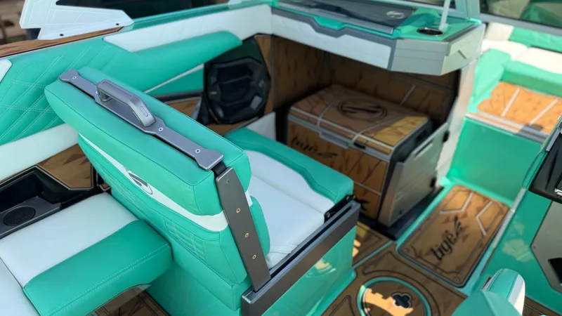 Slide: The Image of The interior of a 2025 Tigé Ultré 23ZX with turquoise and white seating. - 19