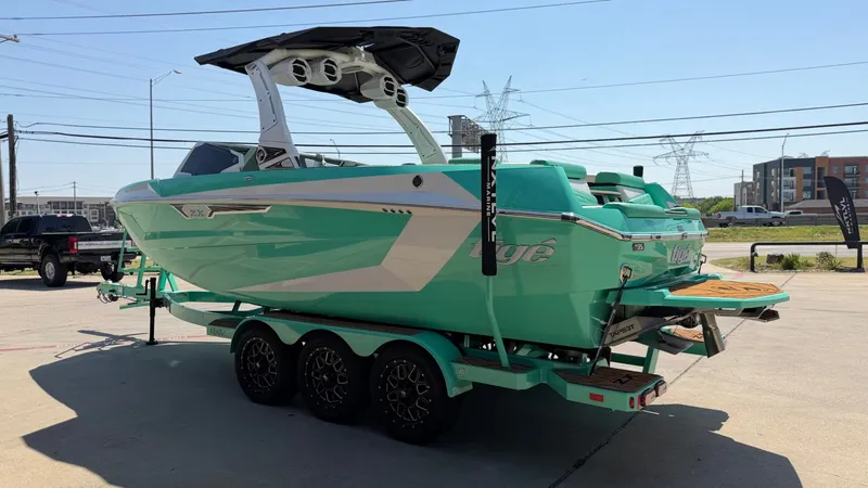 Slide: The Image of A turquoise 2025 Tigé Ultré 23ZX on a trailer in an urban area. - 5