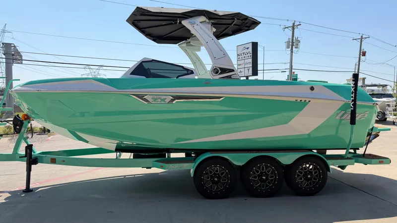 Slide: The Image of A turquoise 2025 Tigé Ultré 23ZX on a trailer. It features a sleek, modern design. - 6