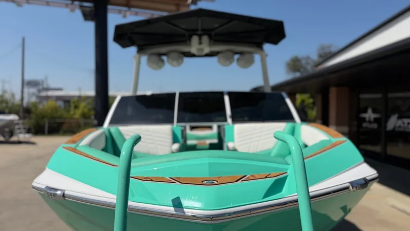 Slide: The Image of 2025 Tigé Ultré 23ZX in vibrant turquoise with sleek design and spacious cockpit. - 9