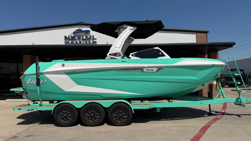 The Image of A turquoise 2025 Tigé Ultré 23ZX on a trailer in front of a building. - 1