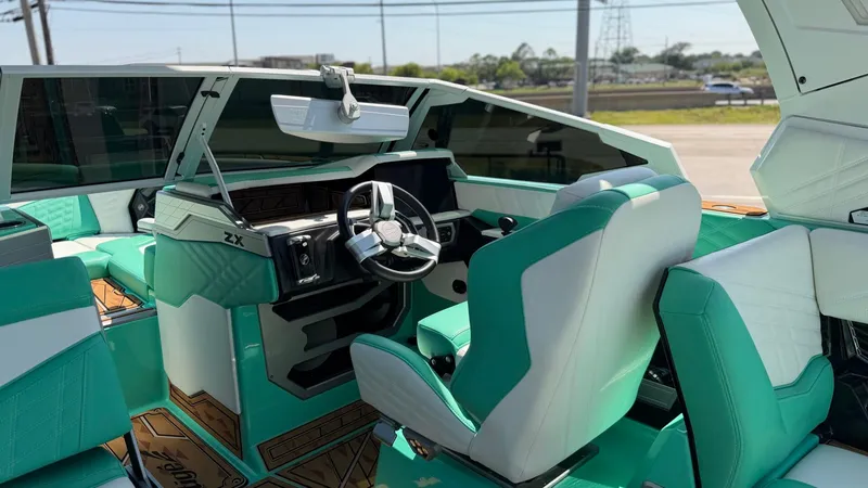 Slide: The Image of The image shows the cockpit of a 2025 Tigé Ultré 23ZX with turquoise seats and modern design. - 21
