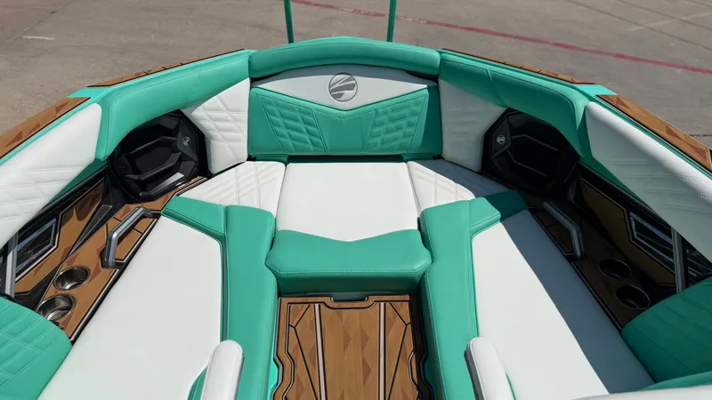 Slide: The Image of The image shows the interior of a 2025 Tigé Ultré 23ZX boat with turquoise and white upholstery. - 26