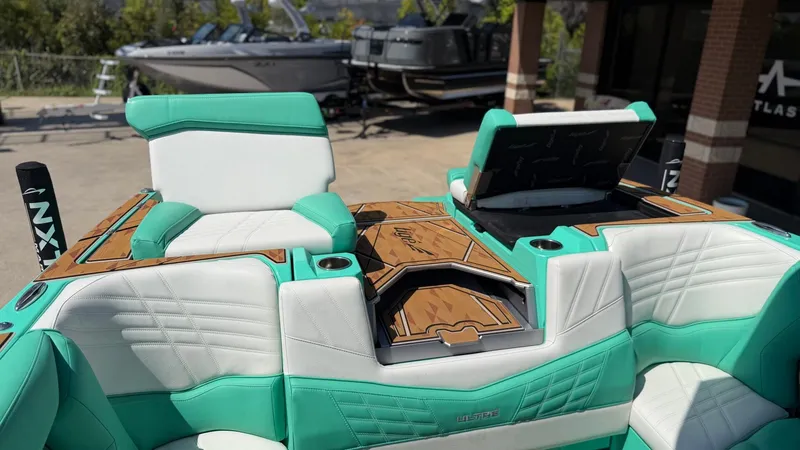 Slide: The Image of The image shows the interior of a 2025 Tigé Ultré 23ZX boat with turquoise seating. - 16