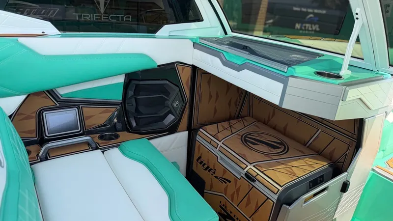 Slide: The Image of The image shows the interior of a Tigé Ultré 23ZX boat with turquoise and white seating. - 25