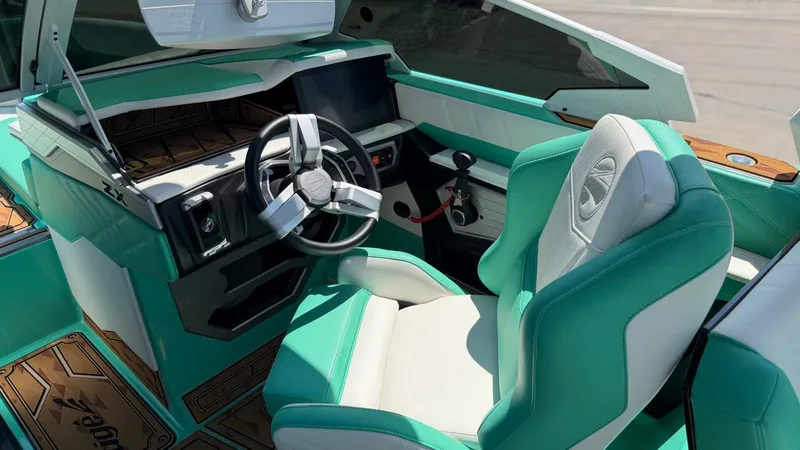 Slide: The Image of The image shows the cockpit of a 2025 Tigé Ultré 23ZX with turquoise and white seating. - 22