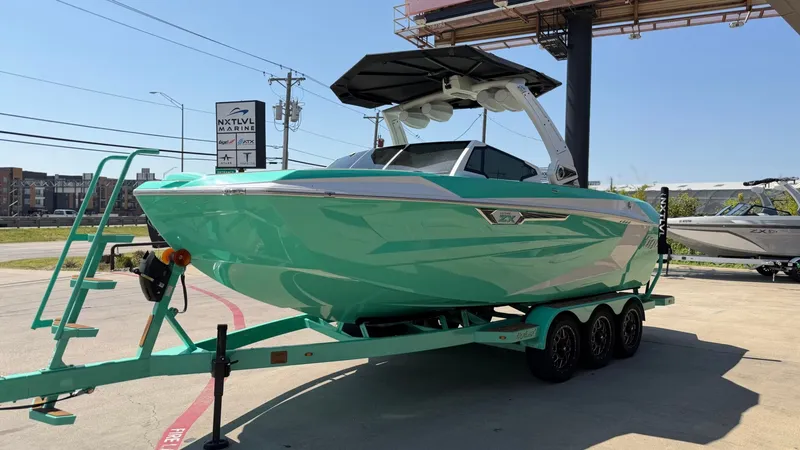 Slide: The Image of A turquoise boat on a trailer with a black canopy and sleek lines. - 7