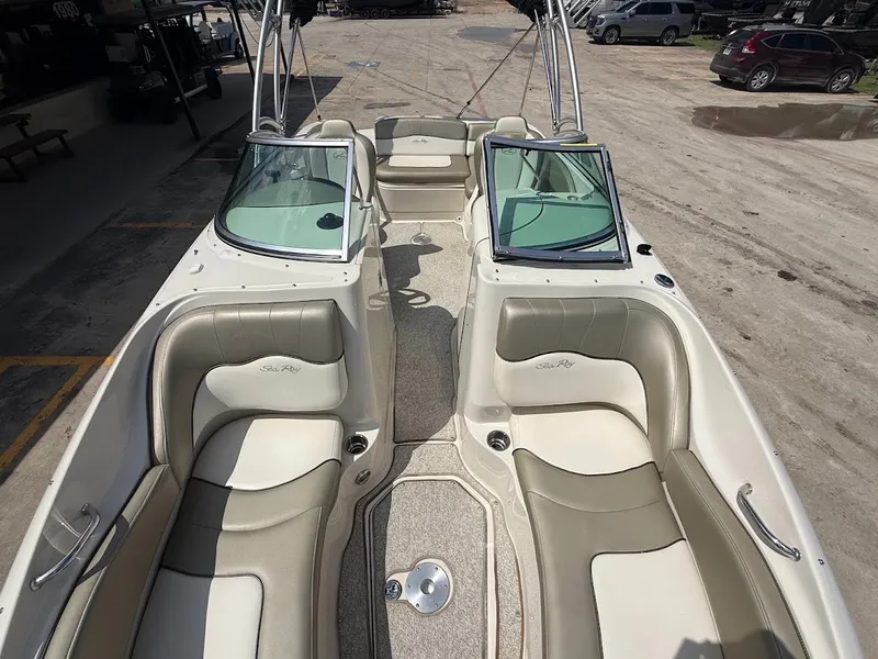 Slide: The Image of The image shows the cockpit of a 2007 Sea Ray 220 Sundeck boat with beige seating. - 27