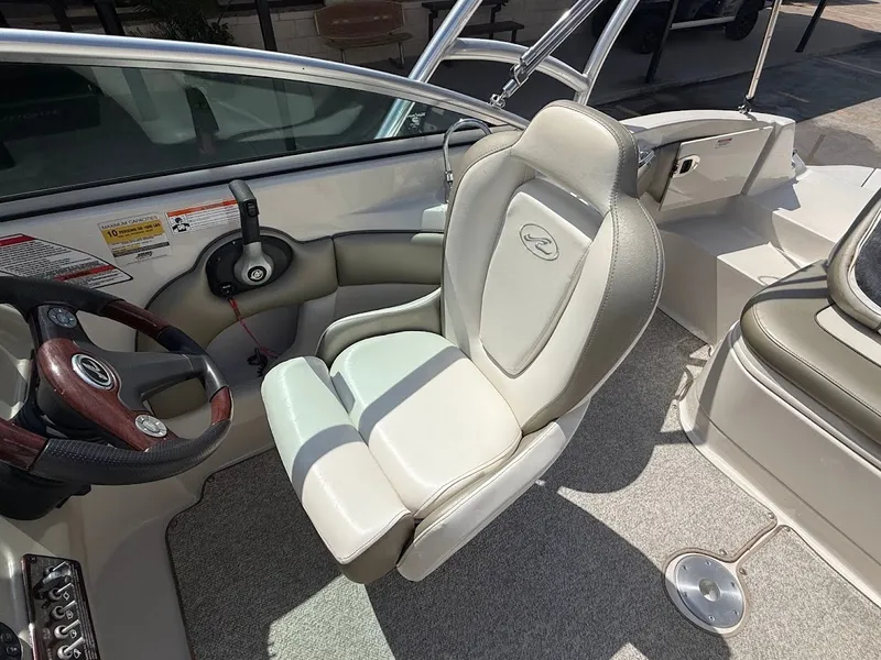 Slide: The Image of The image shows the helm of a 2007 Sea Ray 220 Sundeck with a comfortable captain's chair. - 17