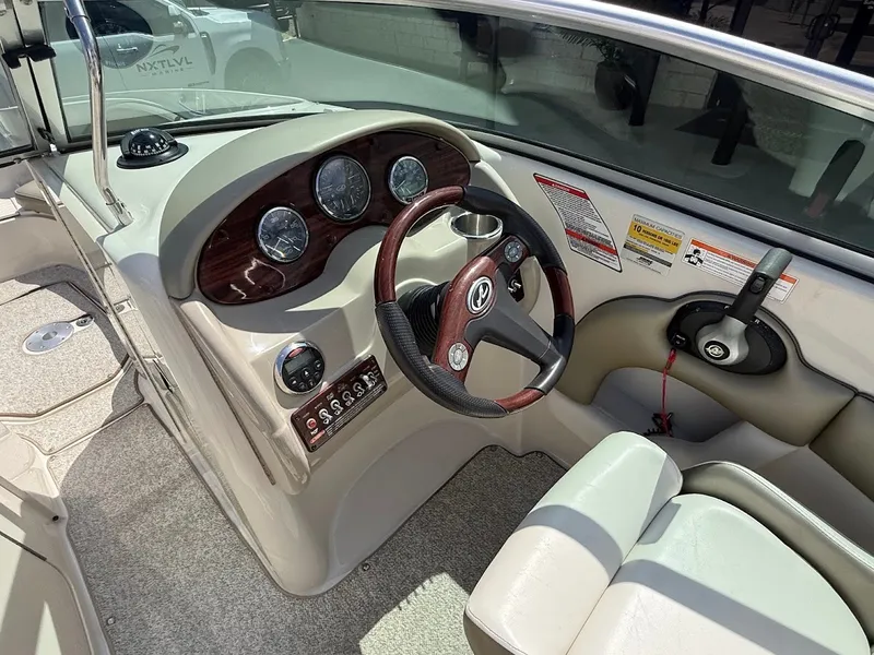 Slide: The Image of The image shows the cockpit of a 2007 Sea Ray 220 Sundeck boat with a sleek dashboard. - 18