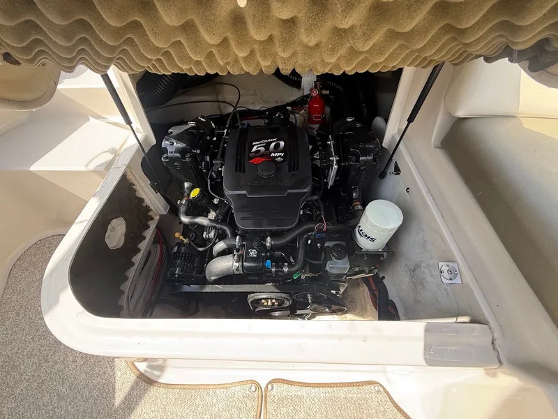 Slide: The Image of The engine compartment of a 2007 Sea Ray 220 Sundeck features a 5.0 MPI engine. - 16