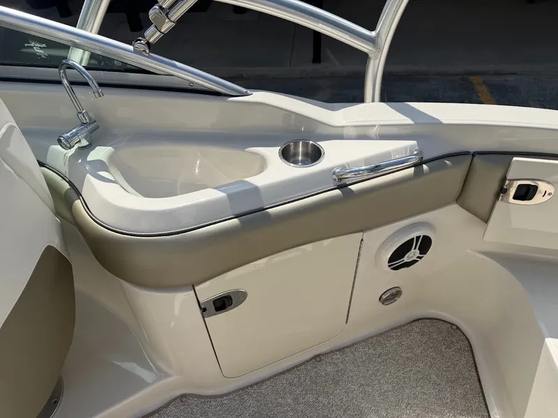 Slide: The Image of The image shows the cockpit of a 2007 Sea Ray 220 Sundeck with a sink and storage. - 15