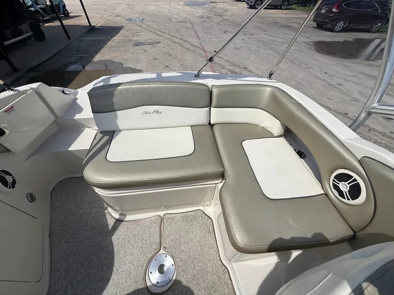 Slide: The Image of The image shows the cockpit of a Sea Ray 220 Sundeck boat with cushioned seating. - 14