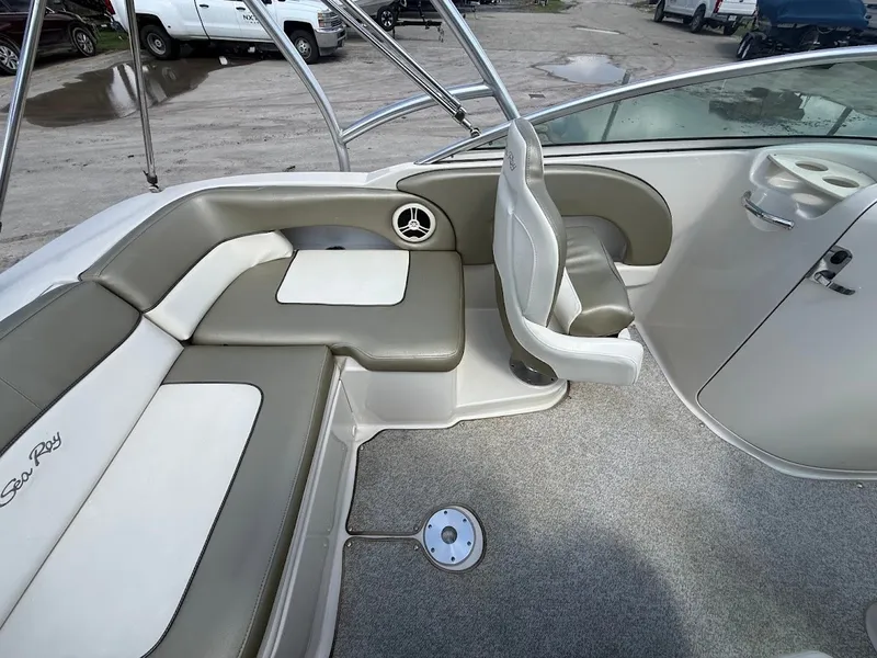 Slide: The Image of The image shows the cockpit of a 2007 Sea Ray 220 Sundeck with gray and white seating. - 13