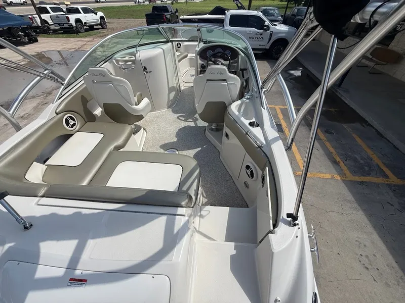 Slide: The Image of The image shows the cockpit of a 2007 Sea Ray 220 Sundeck boat with seating and helm. - 12