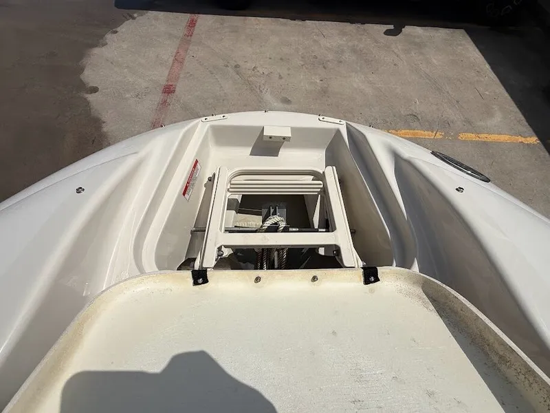 Slide: The Image of The image shows the bow of a 2007 Sea Ray 220 Sundeck boat with open storage. - 25