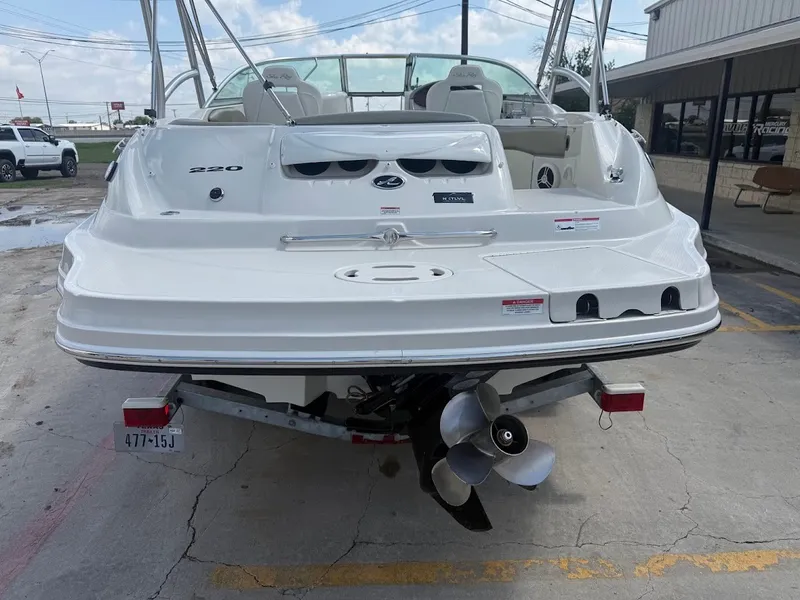 Slide: The Image of A white 2007 Sea Ray 220 Sundeck boat on a trailer, with a visible propeller. - 4