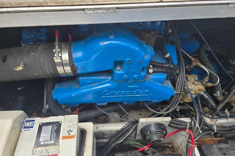 Slide: The Image of Engine compartment of a 1998 Carver 350 Mariner with blue Crusader engine components. - 18