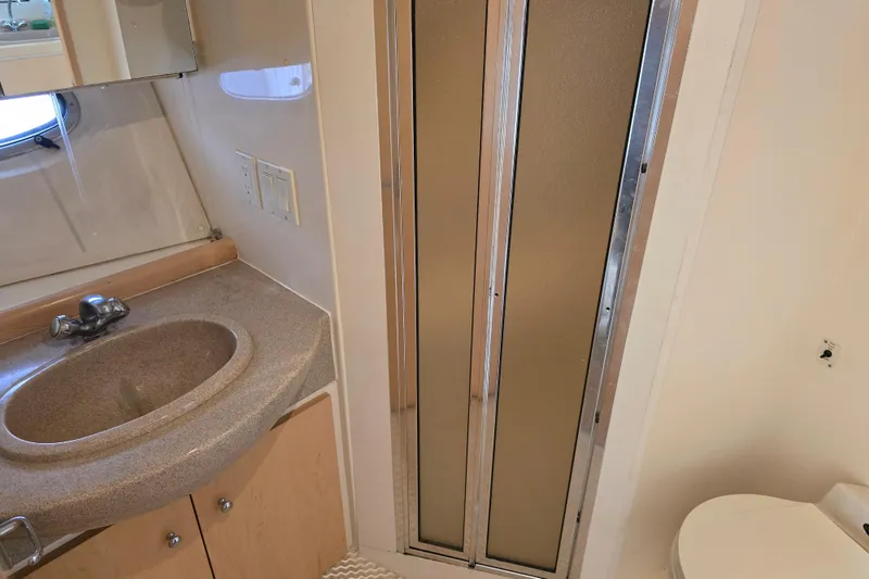 Slide: The Image of Bathroom interior of 1998 Carver 350 Mariner yacht with sink, shower, and toilet. - 36