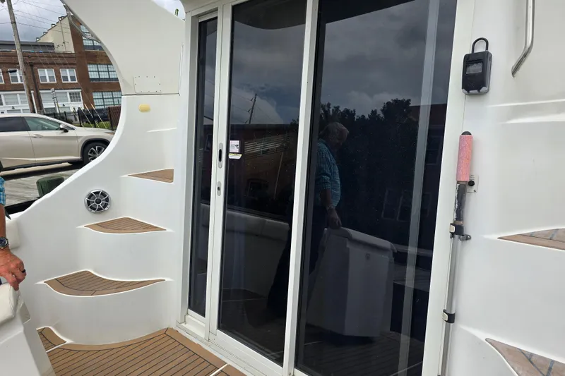 Slide: The Image of 1998 Carver 350 Mariner yacht with sliding glass doors and exterior steps. - 20