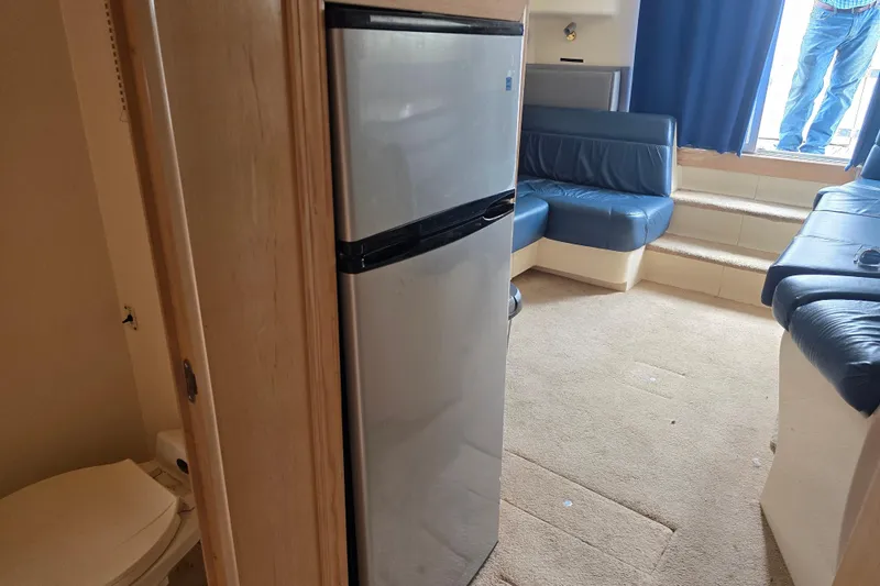 Slide: The Image of Interior of 1998 Carver 350 Mariner yacht with fridge and seating area. - 26
