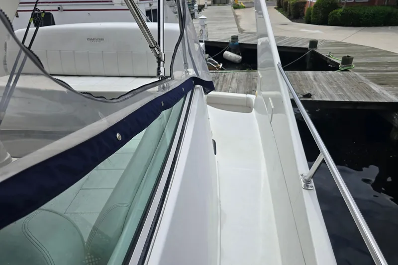 Slide: The Image of 1998 Carver 350 Mariner yacht docked, showcasing sleek design and spacious deck area. - 14