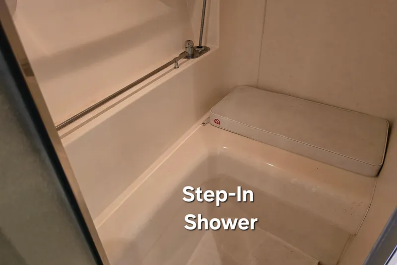 Slide: The Image of Step-in shower in 1998 Carver 350 Mariner boat, featuring a built-in seat. - 37
