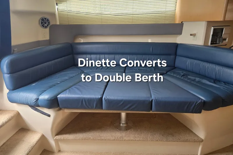 Slide: The Image of 1998 Carver 350 Mariner dinette converts to double berth, featuring blue upholstery. - 23