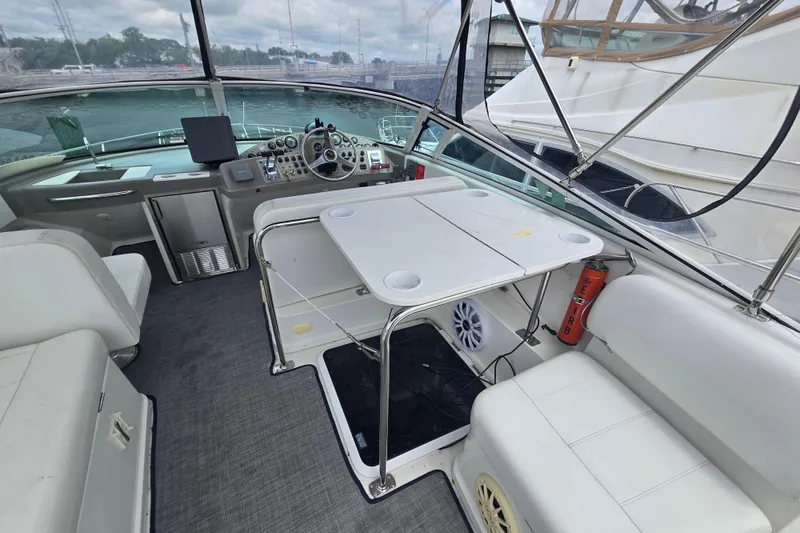 Slide: The Image of 1998 Carver 350 Mariner interior with helm, seating, and table on a yacht. - 8