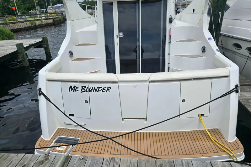 Slide: The Image of 1998 Carver 350 Mariner docked, rear view with "Me Blunder" name visible. - 3