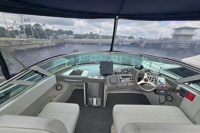 Slide: The Image of Interior view of a 1998 Carver 350 Mariner yacht cockpit with steering wheel and control panel. - 10