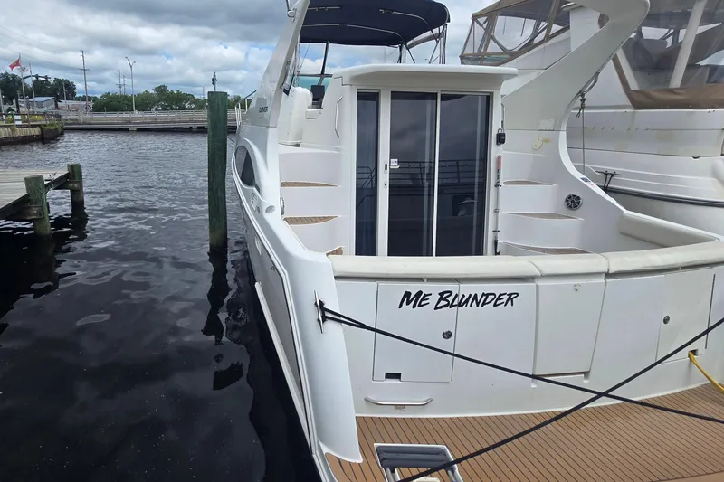 Slide: The Image of 1998 Carver 350 Mariner docked, featuring "Me Blunder" name on stern. - 41