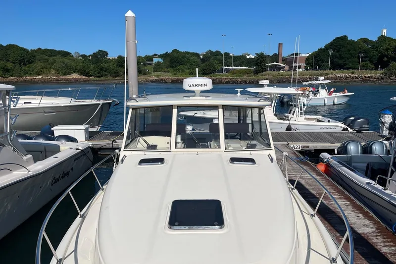 Slide: The Image of 2007 Mainship Pilot 34 Sedan docked at marina with clear blue sky. - 6